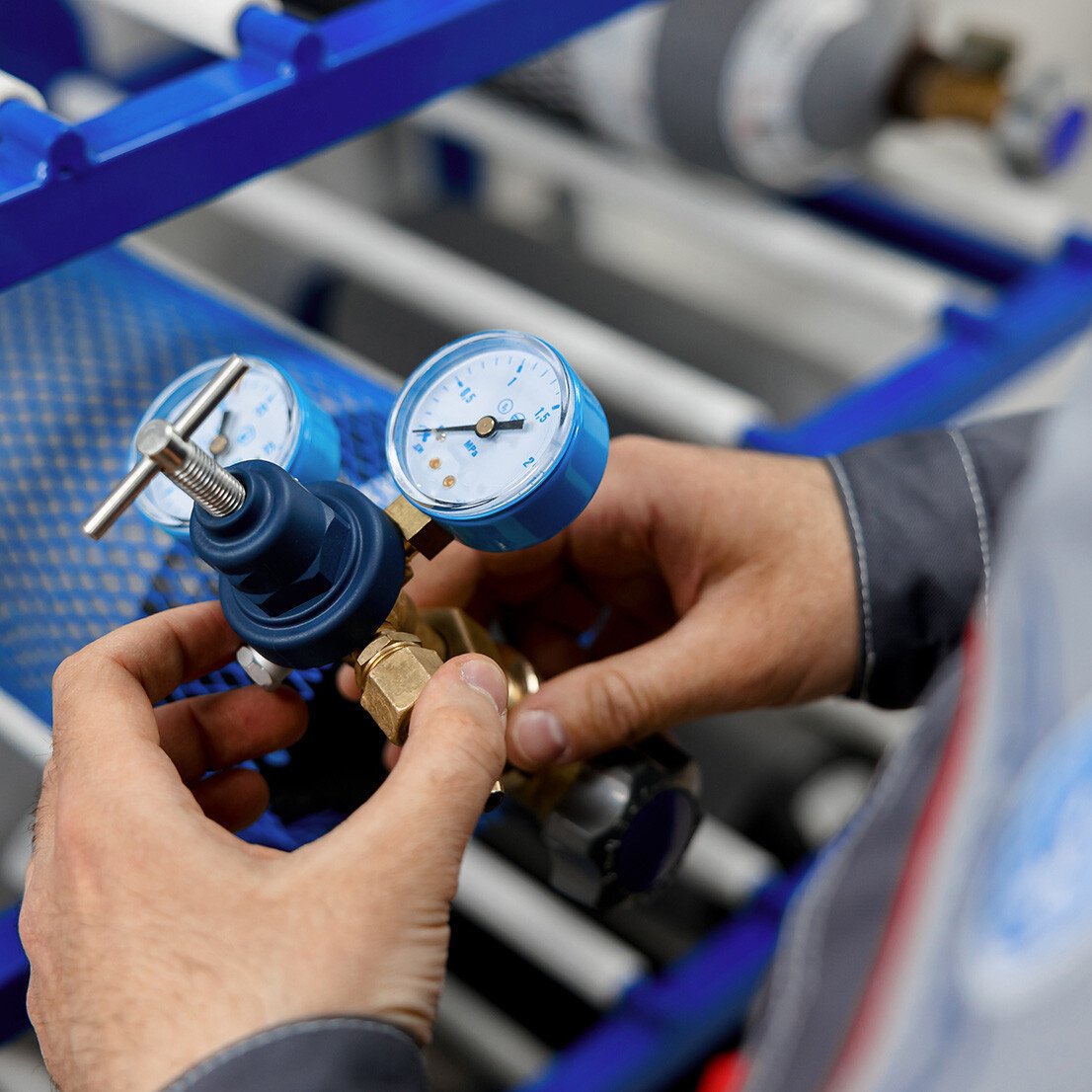 close up of technician adjusting pressure gauges